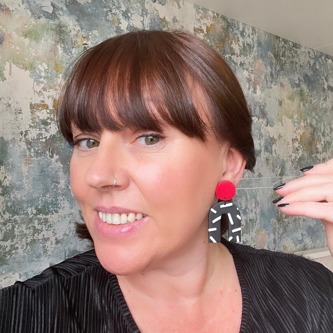Try on picture of Kerry from Kay Jay Clay wearing the Red and monochrome sprinkles arch dangle earrings