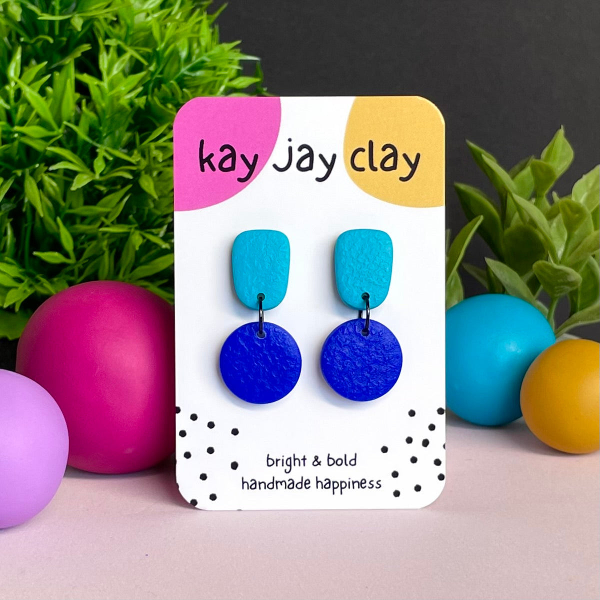 Turquoise & Electric Blue colour pop dangle earrings on Kay Jay Clay branded mounting card