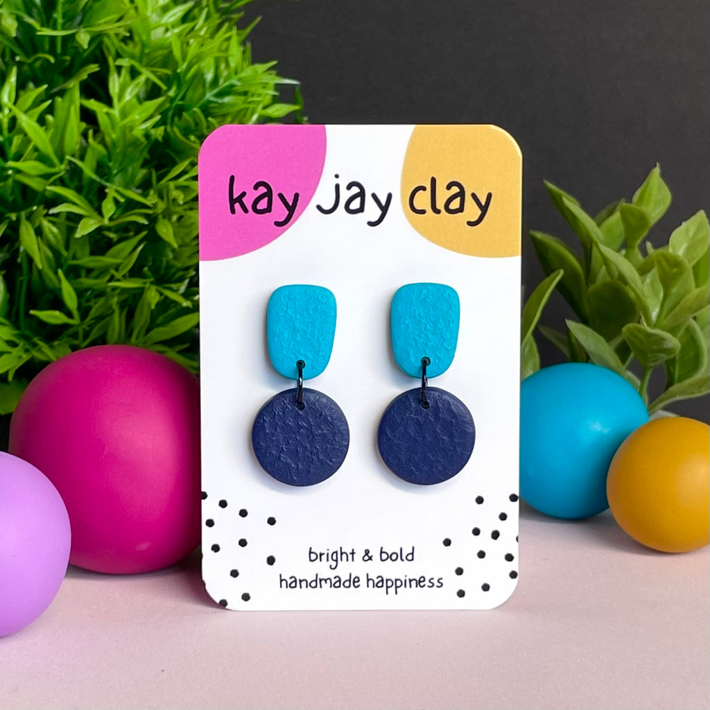 Turquoise & Navy Blue colour pop dangle earrings on Kay Jay Clay branded mounting card