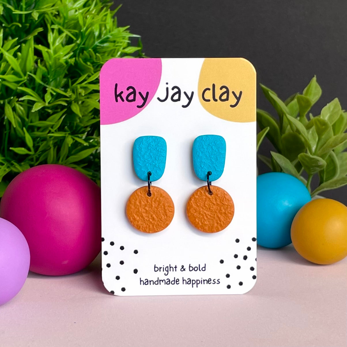 Turquoise & Orange colour pop dangle earrings on Kay Jay Clay branded mounting card
