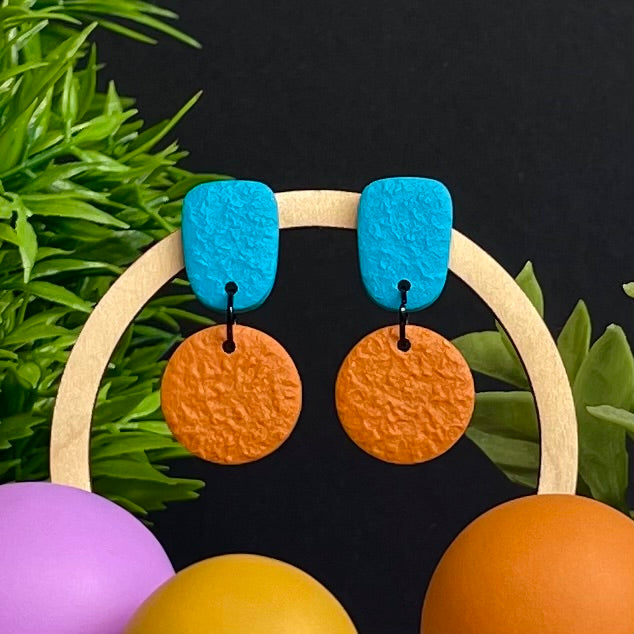 Turquoise & Orange colour pop dangle earrings on hoop display prop