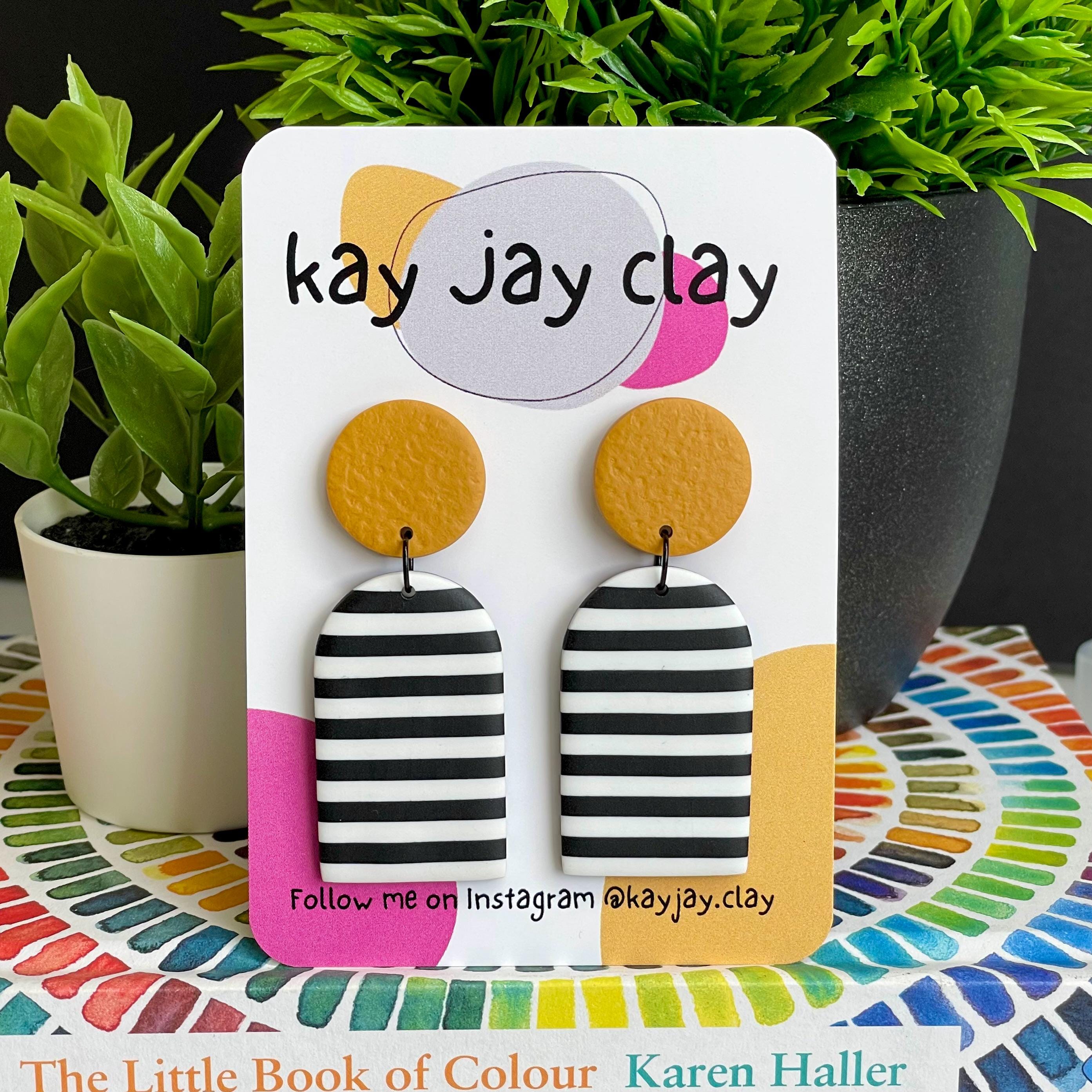 Black & White Striped earrings on Kay Jay Clay mounting card with colourful background 